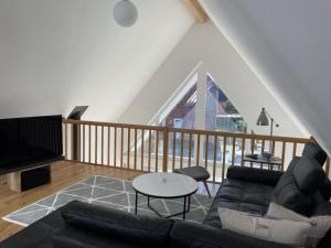 a living room with a couch and a table at Holiday home in Zingst with swimming pool in Zingst