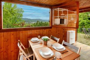 a wooden dining room with a table and chairs at Erdei Kabin Nagymaros in Nagymaros