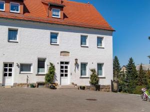 a large white building with an orange roof at Holiday apartment in Tharandt with Wi-Fi in Tharandt