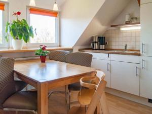 a kitchen with a wooden table and chairs at Holiday apartment in Tharandt with Wi-Fi in Tharandt