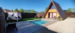 a tiny house with a swimming pool and a tent at Villa Dream House Bihac in Bihać