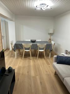 a living room with a table and chairs and a couch at Charmante maison rénovée in Saint-Ciers-sur-Gironde
