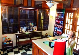 a woman talking on a cell phone in a kitchen at Canario Boutique Hotel in San Juan