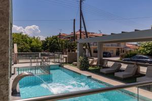 a swimming pool with a water fountain on a balcony at Amalia Deluxe Villas in Nea Vrasna