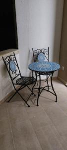 two chairs and a table and a table and chairs at Casa PERLAMARE in Otranto