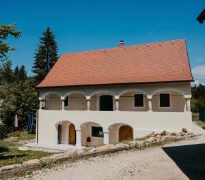 a small white house with a red roof at Golavškov mlin - Eco Heritage Boutique Stay in Prebold