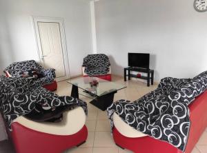 a living room with two chairs and a table at Val's Home in Fier