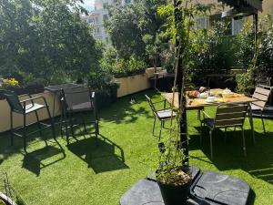 ニースにあるChambre Vue Jardin Alsace Lorraine Victor Hugoの芝生の上にテーブルと椅子がある庭園 +2枚の写真
