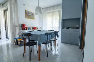 a kitchen with a table and chairs in a kitchen at Aromatika, b&b, affittacamere in Faenza