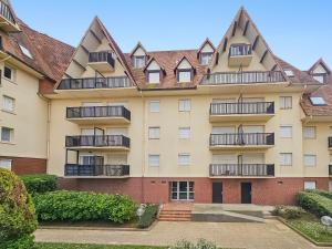 an apartment building with balconies on the side at South-facing terrace, direct beach access in Cabourg