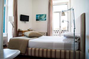 מיטה או מיטות בחדר ב-L'Approdo delle Sirene