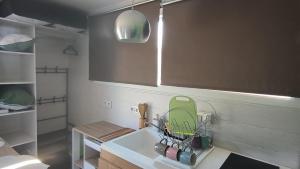 a kitchen with a sink with a green strainer at Tiny house neuve, confortable et parking gratuit in Poitiers