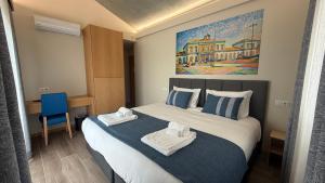 a hotel room with a bed with towels on it at Oporto Station Hostel & Rooms in Porto