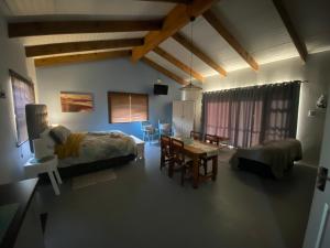 a living room with a couch and a table at Sunset View Self- Catering Yzerfontein in Yzerfontein