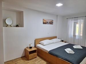 a bedroom with a bed and a mirror and a window at Holiday Home Hidden Hill in Lopar