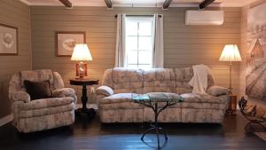 a living room with a couch and a chair at Connie's Retreat - 3 Bedrooms, 2 Baths, Sleeps 11 farmhouse in Tellico Plains