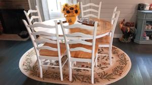a wooden table with four chairs around it at Connie's Retreat - 3 Bedrooms, 2 Baths, Sleeps 11 farmhouse in Tellico Plains