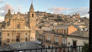 an old building with a clock tower on top of a city at Agira Royal Central Rooms in Agira