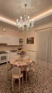 a kitchen with a table with a vase of flowers on it at Agira Royal Central Rooms in Agira