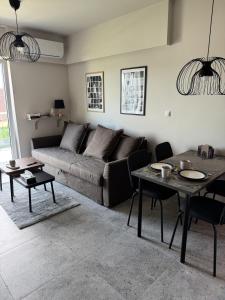 a living room with a couch and a table at Apartament Kasztanówka 