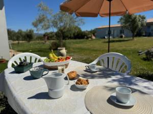 a white table with a bowl of fruit on it at B&B Sensorial Experience in Villamassargia +39 photos