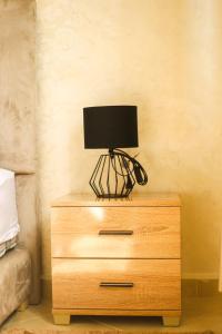 a wooden dresser with a lamp on top of it at Tamraght Apartement Sea View in Agadir +13 photos