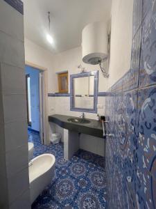 a bathroom with a sink and a mirror and a tub at Casa Nonna Maria in Stromboli