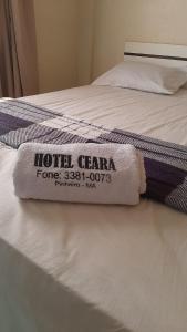 ein Hotel-Gerama-Handtuch auf einem Bett in der Unterkunft O melhor custo benefício da cidade - Hotel Ceará in Pinheiro + 5 Fotos