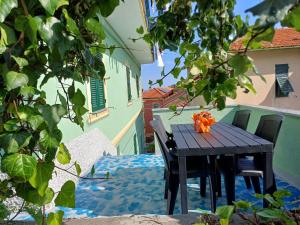 a wooden table and chairs sitting on a patio at I Pippodi in Celle Ligure