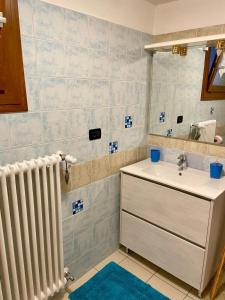 a bathroom with a sink and a radiator at La casa di Rosy in Enego +35 photos