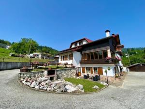 a large house with a landscaping in front of it at La casa di Rosy in Enego