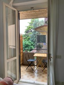 a sliding glass door leading to a patio with a table at Verde Corsica 137 in Brescia