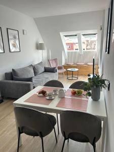 a living room with a table and chairs and a couch at A top-floor modern apartment Located 100 meters from the beach in Fuengirola