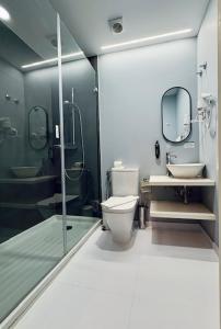 a bathroom with a toilet and a sink and a shower at Lisbon City Inn Hotel by City Hotels in Lisbon +26 photos