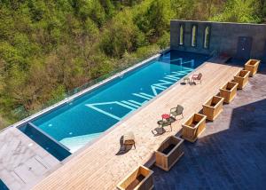 an overhead view of a swimming pool with a wooden deck at Dilijan Inn Hotel and Restaurant in Dilijan