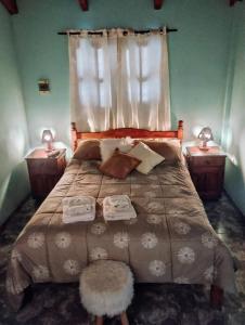 a bedroom with a large bed with two night stands at Belgrano in San Fernando del Valle de Catamarca