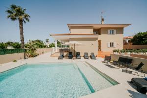 a villa with a swimming pool and a house at Villa Victoria Paradise in Cala en Blanes