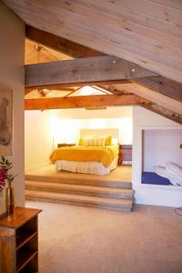 a bedroom with a bed with yellow sheets and a fireplace at Mountain Jungalow Chalet, 3 min walk to Royal Gorge Train in Canon City