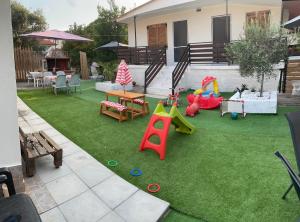 a backyard with a play area with a playground at AlMa Studios in Asprovalta