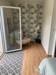 a bedroom with a mirror and a bathroom with a sink at Chambre calme in Tremblay En France +1 photo