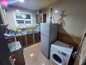 a kitchen with a washing machine and a refrigerator at Al Mohairi Tower-Cool Place for ur Stay-Well Furnished Studio in Ajman 