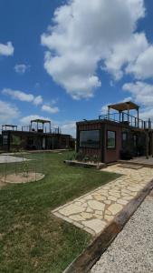 a building with two windows on top of a field at La Rioja Station Patio 1br Wine Escape in Fredericksburg