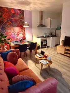 a living room with a couch and a table with a laptop at BOUTIQUE LUXURY City Center in Alicante