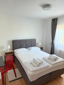 a bedroom with a bed with two towels on it at Apartment Gabriela in Rakovica