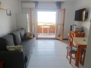 a living room with a couch and a table at Estudio naturista 1 in Vera