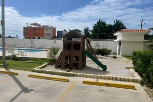 a playground with a slide next to a pool at Sunshine Palmares de Caleta in La Romana