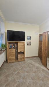 a living room with a flat screen tv on a wall at Baltic Swans - Studio in Sopot