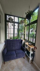 a living room with a blue couch and a table at Baltic Swans - Studio in Sopot