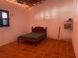 a room with a bed in the corner of a room at Casa Pitombeira in Aracati +19 photos
