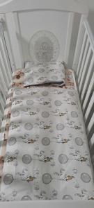 a small bed with two pillows and a blanket on it at Apartman Aydan in Jajce